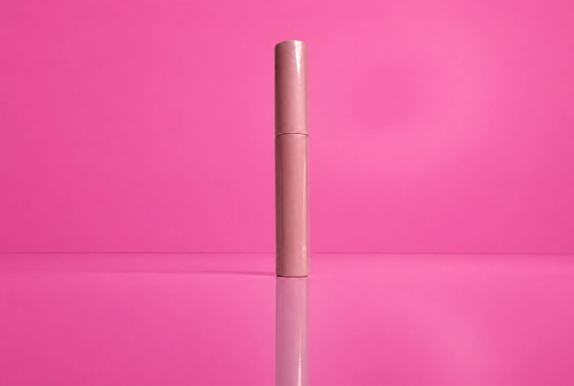 Lash Barb Beauty Super Sticky Lash Glue in a pink tube on a Barbie-pink backdrop